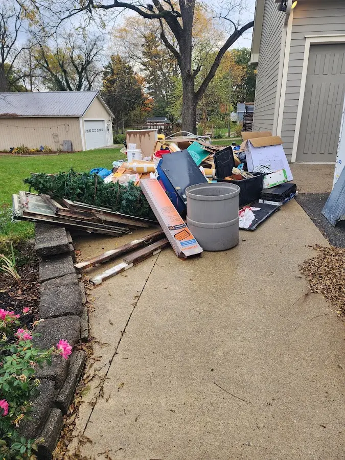 Dumpster being loaded with debris for 12 Yard Dumpster Rental in Ipswich